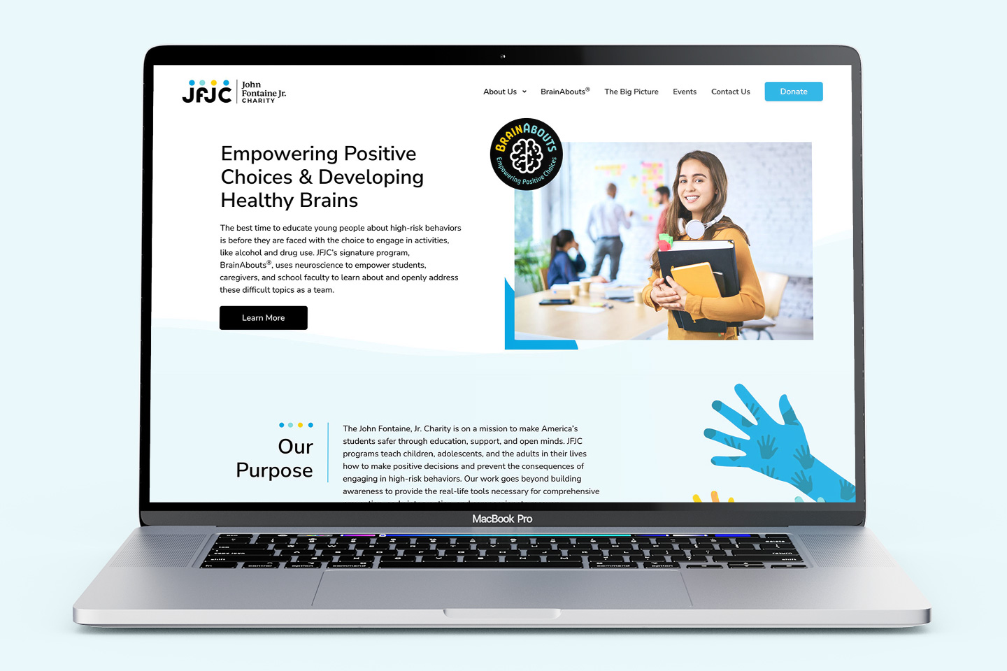 JFJC website displayed on a laptop showcasing homepage and site layout