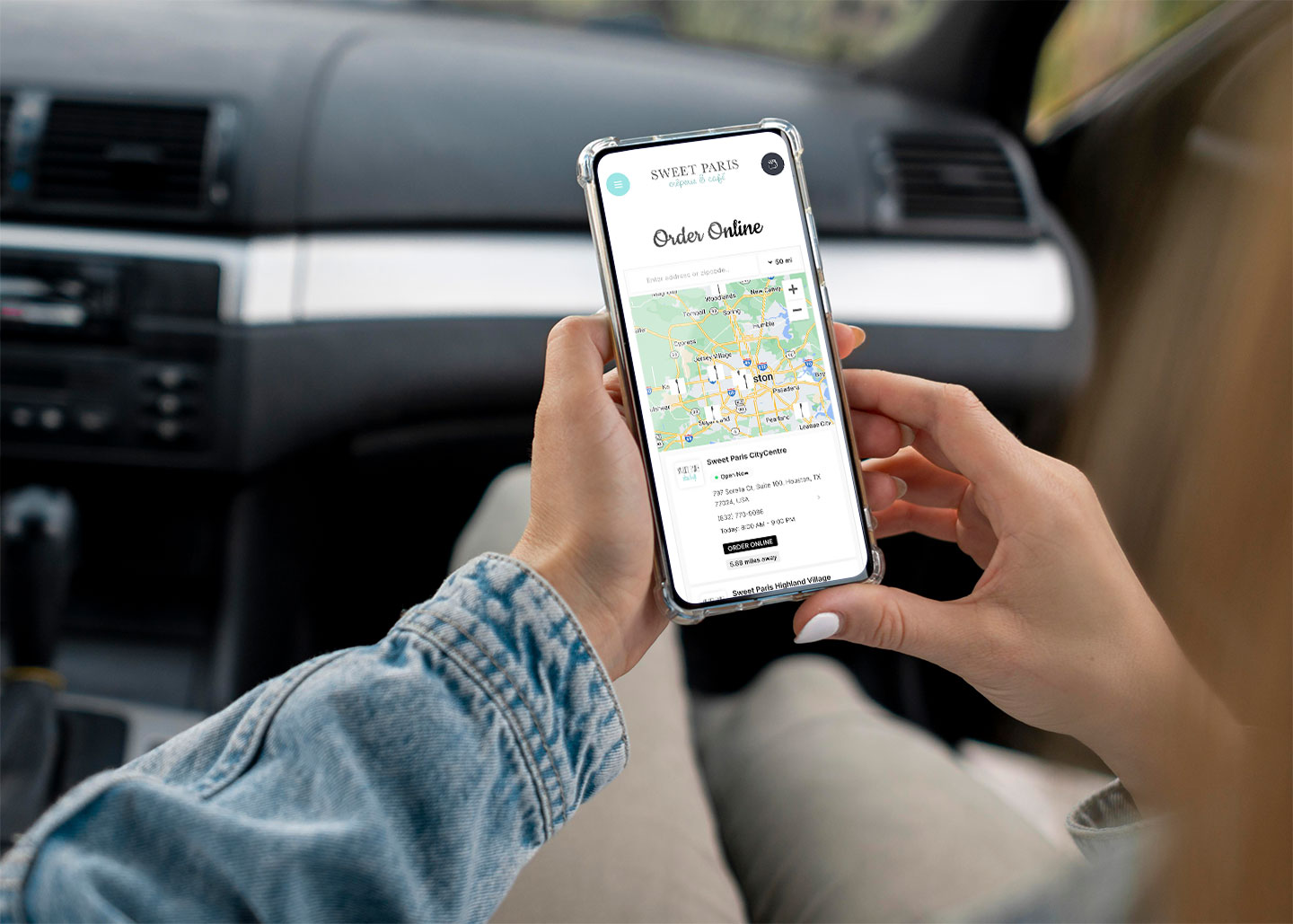 Sweet Paris Crêperie mobile website displayed on a phone as a passenger arrives, illustrating real-world mobile usage